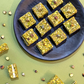 Pistachio crumbles sandwiched with white chocolate  - 250gms